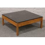 A square formed coffee table with ebonised top, 75.5cm x 75.5cm x 32cm.