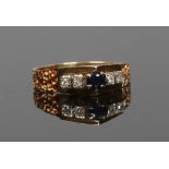 A vintage 18ct gold sapphire and diamond ring with abstract setting and textured shoulders, size L.
