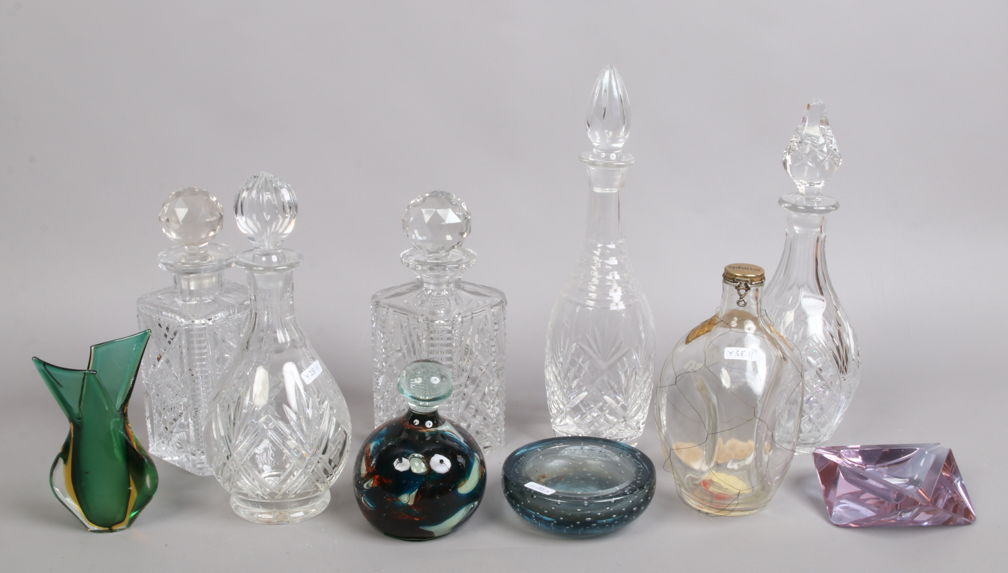 A group of mixed glassware to include cut glass decanters, controlled bubble ash tray, art glass