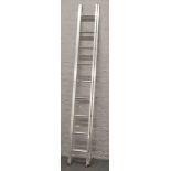 A set of Titan Ladder & Case Co. Ltd aluminium extending ladders, closed 2.8m open 4.8m.