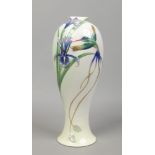 A Franz porcelain baluster vase moulded in relief with a hummingbird and orchids.