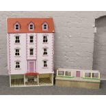 A large painted dolls house in the form of a Victorian three story town house, pre-wired with low