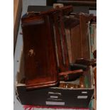 A box of wooden wares including book troughs, turned candlesticks and wall brackets etc.