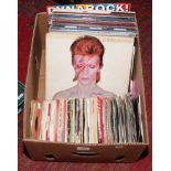 A box of approximately 29 L.P records and over 100 singles to include Queen, David Bowie, Kiss, Thin