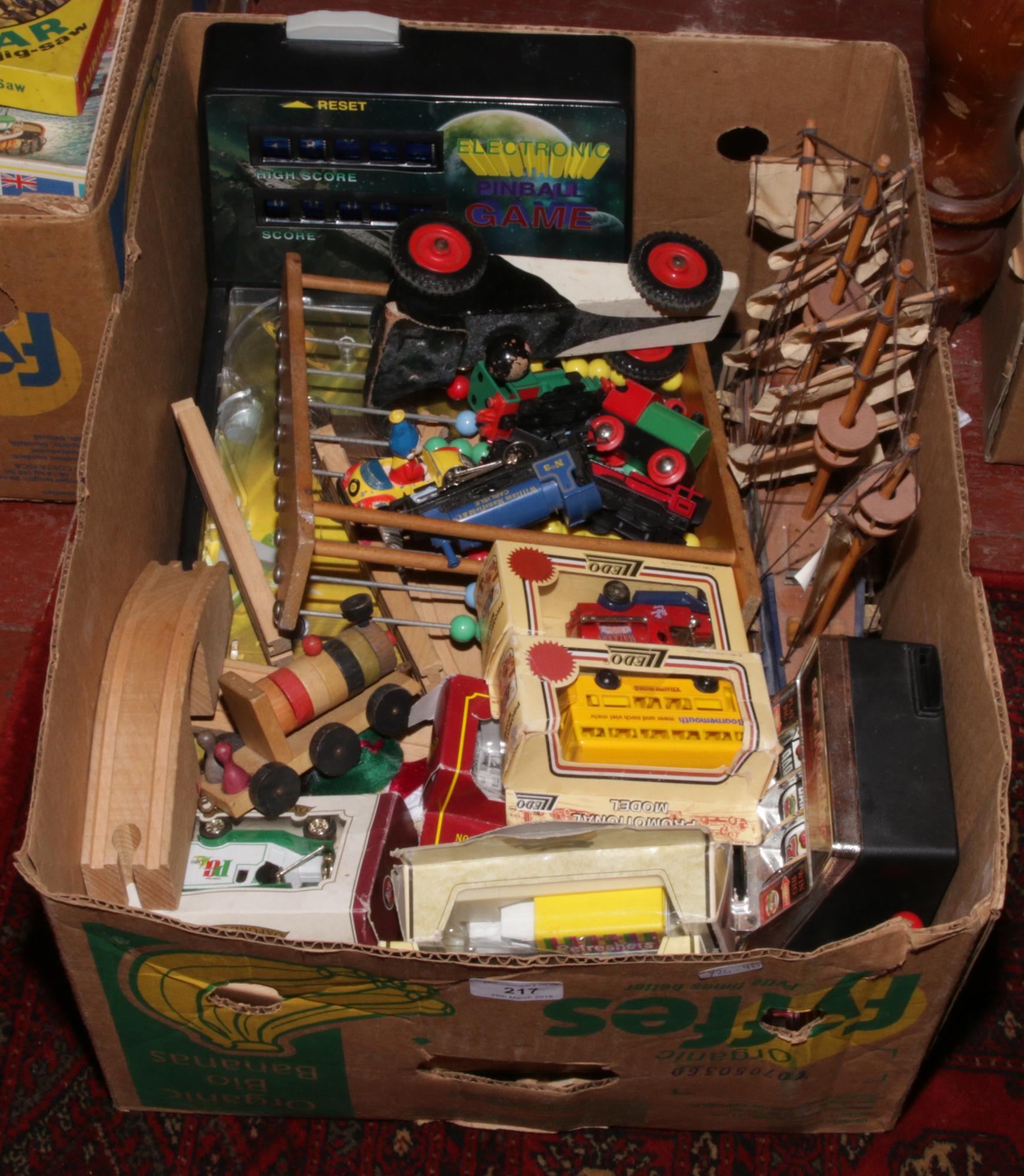 A box of toys including boxed Diecast vehicles, wooden train set, pinball games etc.