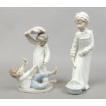 A Nao figure of a young girl washing along with a Nao figure group of two children having a pillow