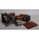A Compur Bellows camera, Coronet Conway box camera, Trianto Cinemax 8 Cine camera and a Bolex