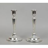 A matched pair of Edwardian silver weighted table candlesticks with detachable nozzles by Martin