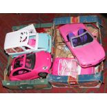 Two boxes of Barbie dolls and vehicles.