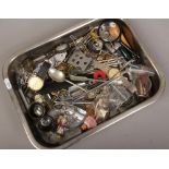 A tray of collectables to include quartz wristwatches, military buttons, badges, pen knives etc.