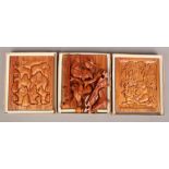 Three carved hardwood jigsaws, stands as a display when not in use.