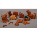 A box of nine carved hardwood animal trinket puzzle boxes.