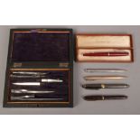 A box of pens including Conway Stewart fountain pen, boxed Parker 51 and a rosewood cased set of