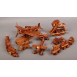 A collection of carved hardwood miniature toys, ornaments, rocking horse, four models of aircraft's,