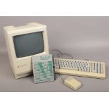 An Apple Macintosh Plus with keyboard and mouse along with Macgolf game.