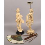 A composite oriental figure of a woman along with a similar smokers stand, hand fan and pair of chop