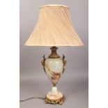 A brass and onyx table lamp of baluster form with ivory silk shade.