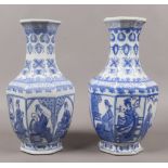 A pair of octagonal baluster shaped vases decorated with oriental figures, 37cm tall.