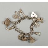 A silver charm bracelet with heart shaped clasp.