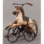 A child's miniature carved wood and metal toy horse tricycle.