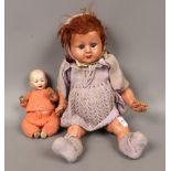 A small German bisque head doll and a 1960s composite doll.