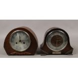 A dome carved oak eight day Smiths Enfield mantel clock, chiming on a coiled gong, along with