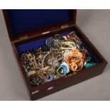 A mahogany cutlery box with contents of costume jewellery to include necklaces, dress rings,