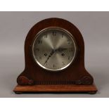 A German oak cased 8 day mantel clock with silvered dial and housing Junghans movement.