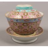 A Chinese famille rose rice bowl and cover on stand printed seal marks.Condition report intended