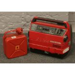 A Honda EX650 petrol generator and red painted metal fuel can.