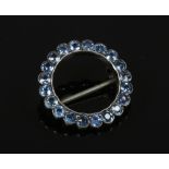 A white metal and tanzanite brooch.