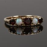 A 9ct gold five stone ring set with opals and garnets, size N1/2.