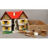 A vintage painted dolls house possibly Triang, along with a box of dolls house furniture.