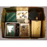 A tin of mixed costume jewellery including boxed Celtic brooch, Park Lane compact and vesta etc.