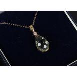 A cased 9ct gold green amethyst and diamond pendant on trace chain.