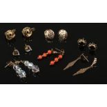 Seven pairs of 9ct gold earrings including sapphire studs and coral etc.