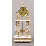 A ceramic mantle clock with floral and gilt decoration and figural finial.