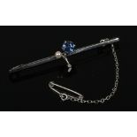 A cased 9ct white gold bar brooch set with a cornflower blue sapphire and pearl.