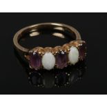 A 9ct gold opal and amethyst four stone ring, size Q1/2.