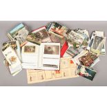 A box of vintage postcards loose and in albums to include colour and monochrome examples.