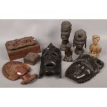 A collection of mainly carved wooden items to include masks, busts, boxes etc.