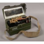 A World War II original British Army portable field telephone handset in olive green painted steel