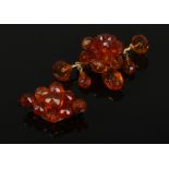 Two amber set brooches.