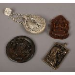 Four oriental pieces including altered jade pendant and a white metal pierced scent bottle.