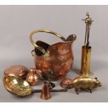 A collection of copper and brass to include helmet shaped coal scuttle, fire side companion stand,