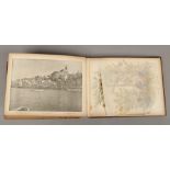 A cased olive wood bound album containing pressed flowers and pictures of the holy land, Jerusalem.