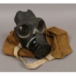 A WWII gas mask in carry case with outfit anti dimming MK VI tin.