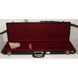 A leather and metal bound rifle case with red felt lining interior.