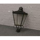 An outdoor garden lantern top in the for of a Victorian street light.