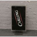 An illuminating wall mounting Carling advertising sign.Condition report intended as a guide only.